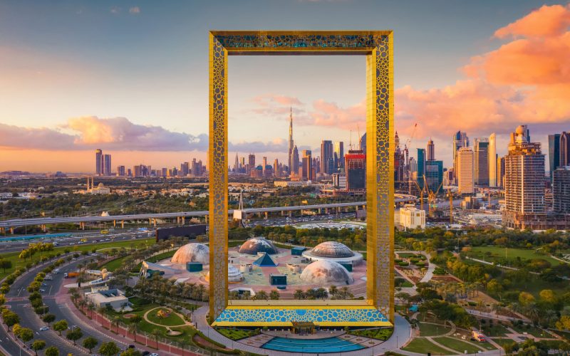 Aerial view of Dubai Frame, Downtown skyline, United Arab Emirates or UAE. Financial district and business area in smart urban city. Skyscraper and high-rise buildings at sunset.